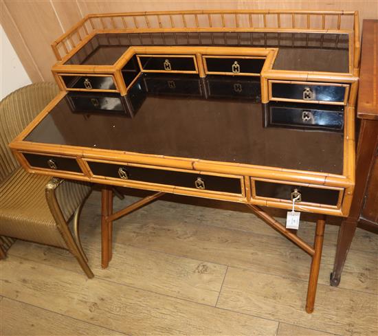 A faux ebony and bamboo desk W.104cm